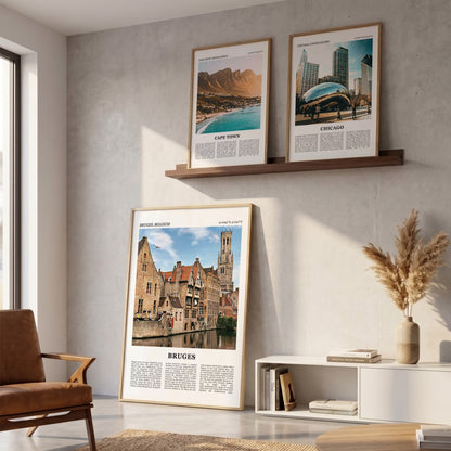 Drie ingelijste posters boven de bank in de woonkamer met Brugge Fotoposter – Kleur in het groot